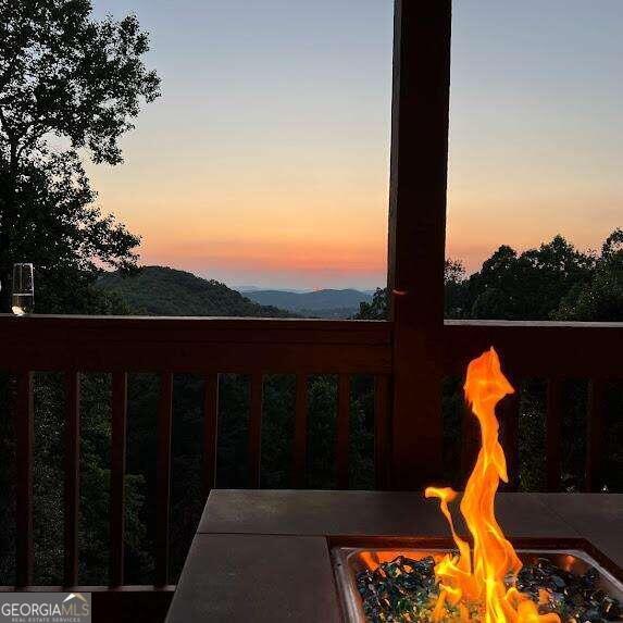 exterior space with an outdoor fire pit and a mountain view