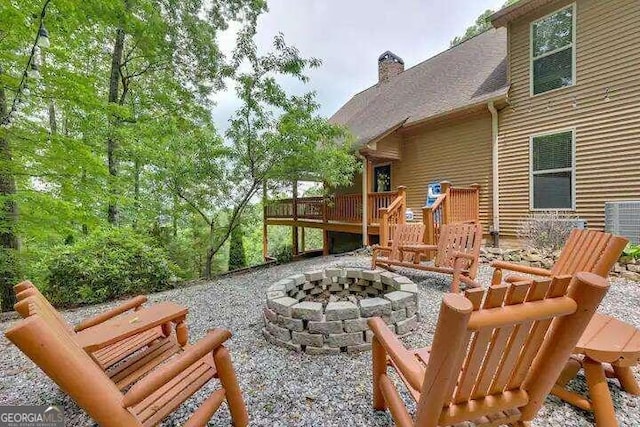 view of patio featuring a wooden deck and an outdoor fire pit