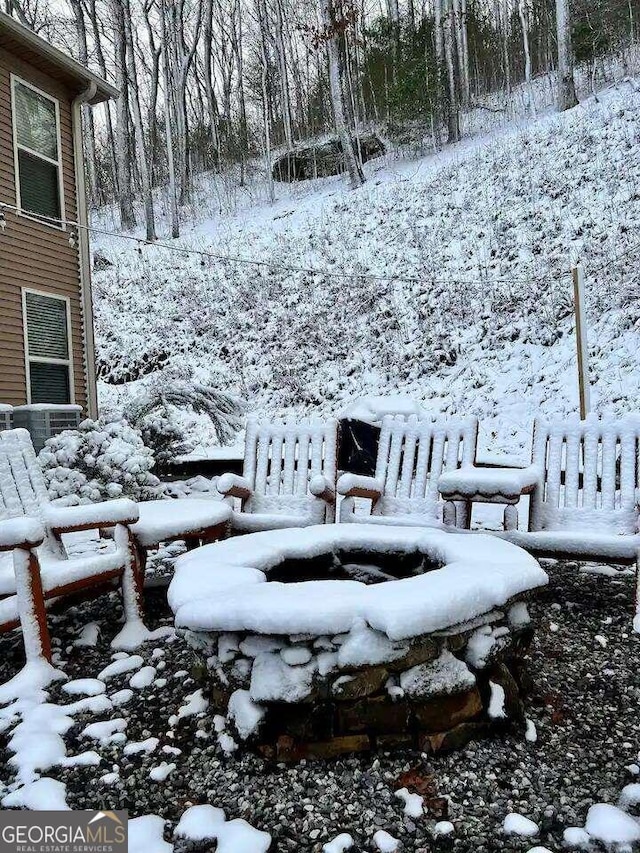 snowy yard with central AC unit