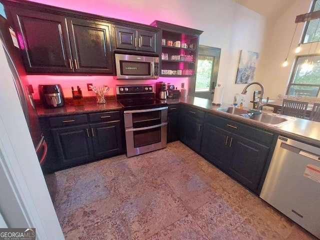 kitchen featuring stainless steel appliances, plenty of natural light, sink, and kitchen peninsula