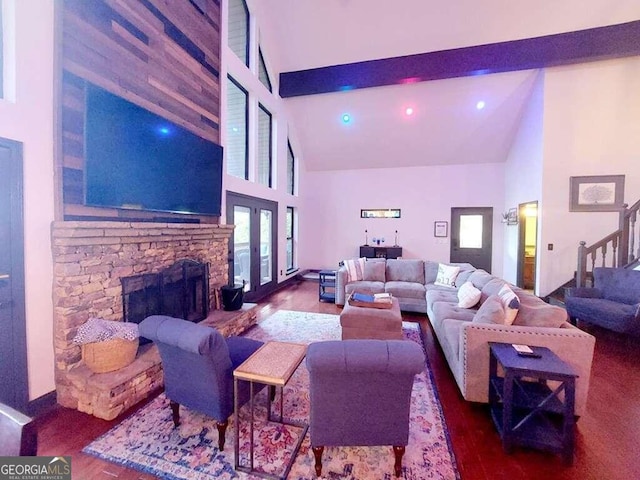 living room with a fireplace, wood-type flooring, french doors, and high vaulted ceiling