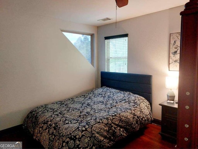 bedroom with ceiling fan and dark hardwood / wood-style floors