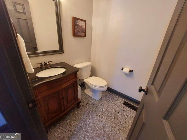 bathroom with toilet and vanity