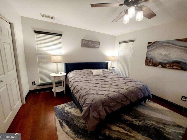 bedroom with ceiling fan and dark hardwood / wood-style floors