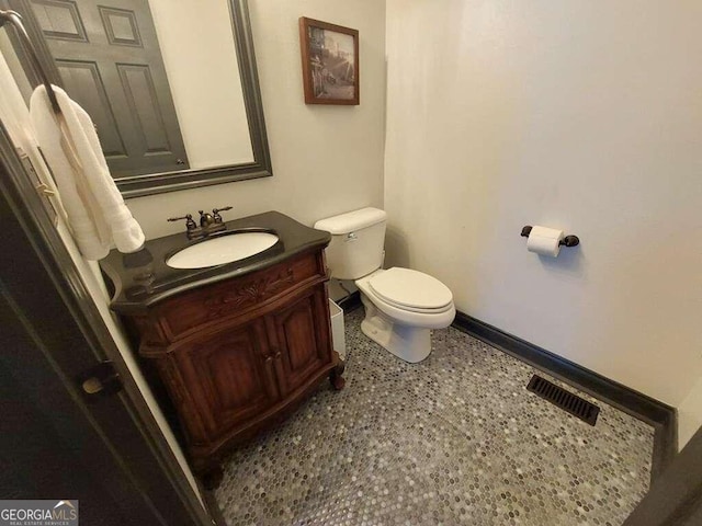 bathroom featuring tile patterned flooring, vanity, and toilet