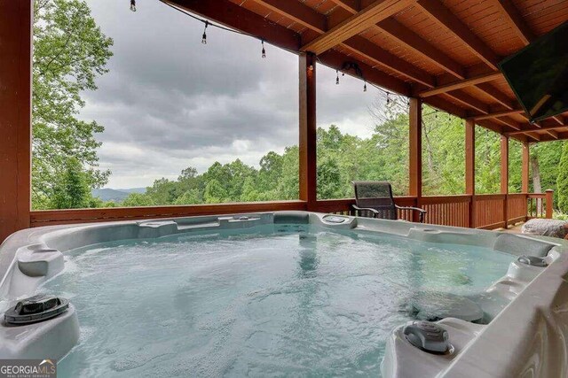 view of pool featuring a hot tub