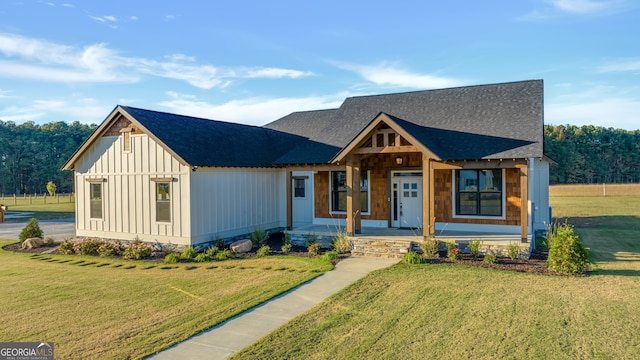 view of front of home with a porch and a front yard