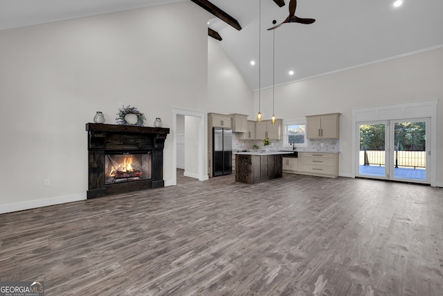 unfurnished living room with high vaulted ceiling, beamed ceiling, wood-type flooring, and ceiling fan