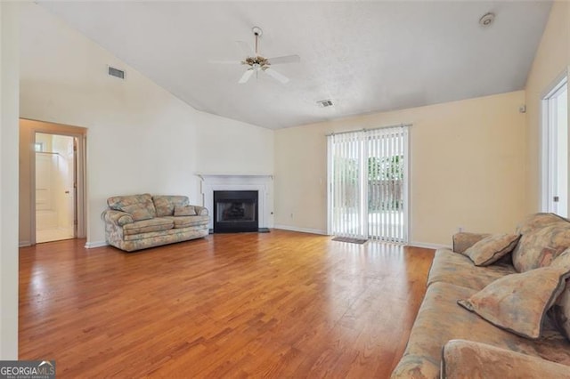 living room featuring hardwood / wood-style floors, ceiling fan, and high vaulted ceiling