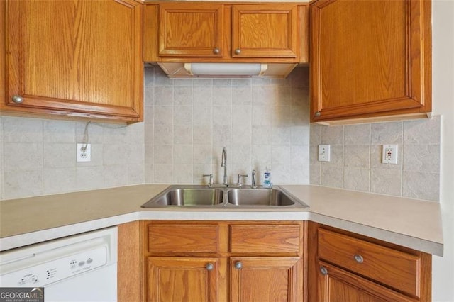 kitchen featuring dishwasher, decorative backsplash, and sink