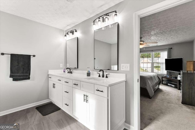 bathroom with vanity, a textured ceiling, and ceiling fan