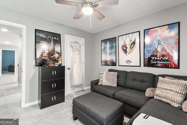 carpeted living room featuring a textured ceiling and ceiling fan