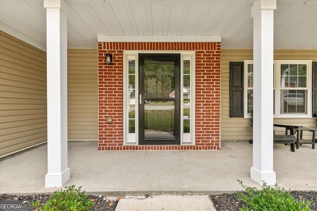 doorway to property featuring covered porch