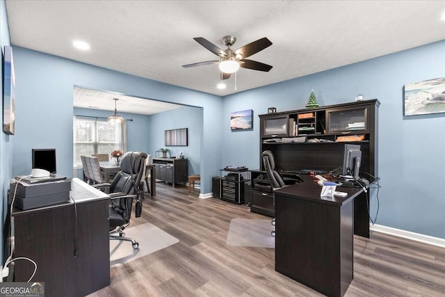 office space with a textured ceiling, hardwood / wood-style flooring, and ceiling fan