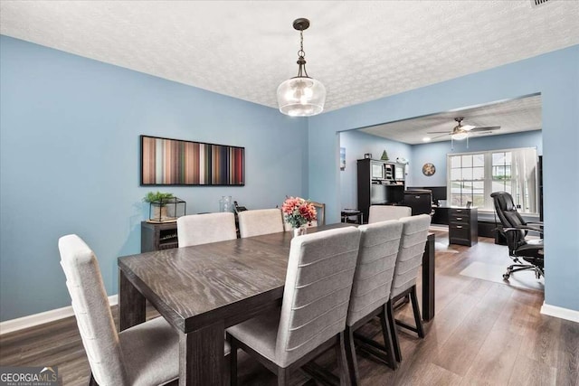 dining room featuring a textured ceiling, hardwood / wood-style flooring, and ceiling fan