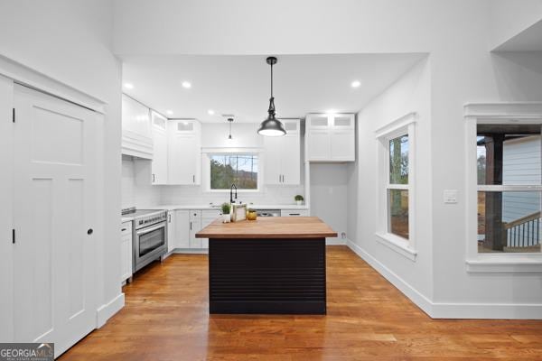 352 Welcome To Arnco Rd, Newnan, GA 30263 - kitchen featuring white cabinetry, wood counters, stainless steel range with electric stovetop, and a healthy amount of sunlight