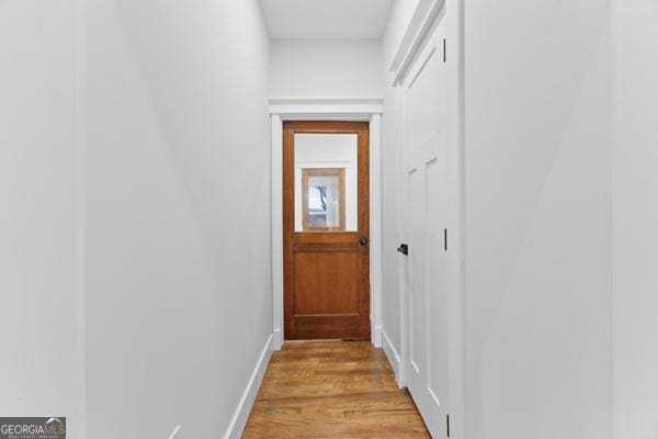 entryway with light wood-style flooring and baseboards