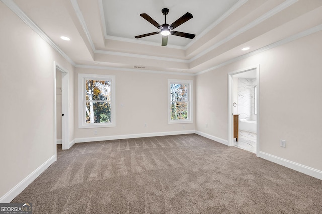 carpeted empty room with a raised ceiling, crown molding, and ceiling fan