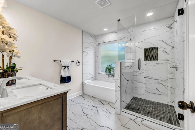 bathroom featuring vanity and independent shower and bath