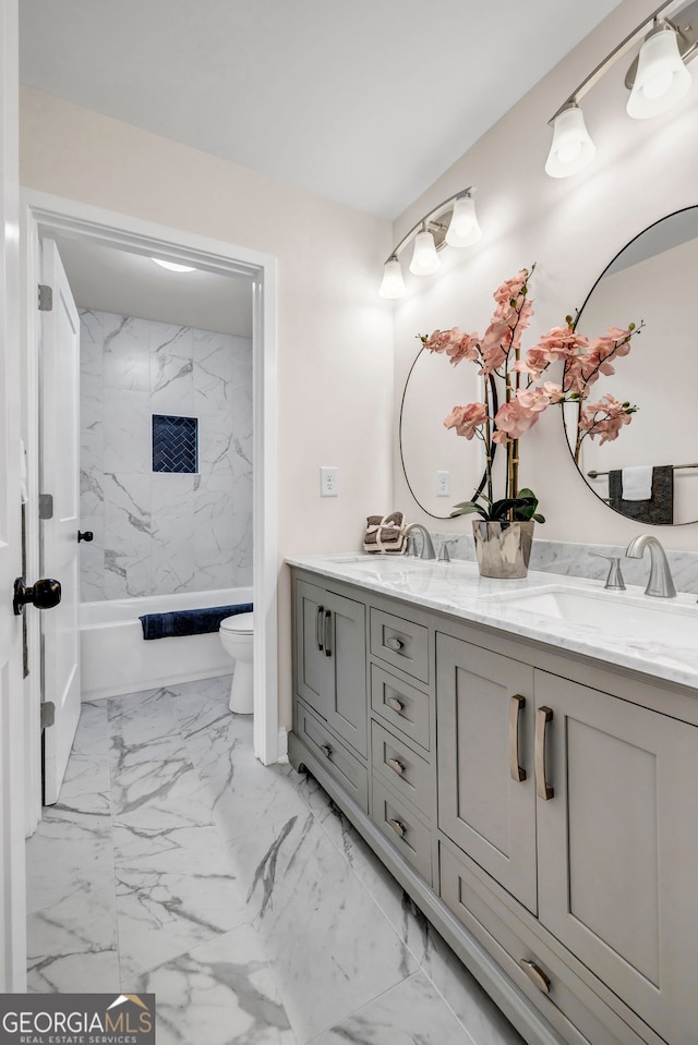 full bathroom with vanity, toilet, and tiled shower / bath combo