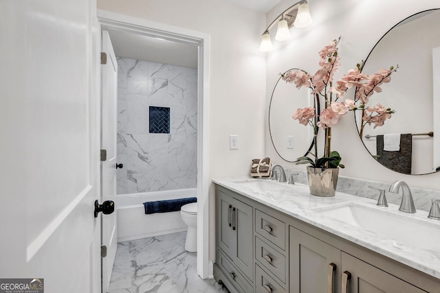 full bathroom featuring vanity, toilet, and tiled shower / bath combo