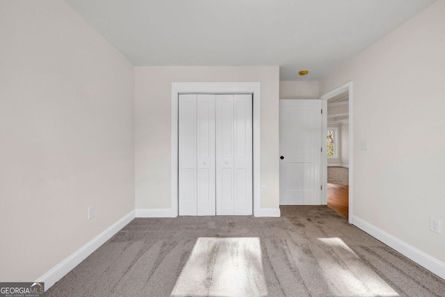 unfurnished bedroom featuring carpet floors and a closet