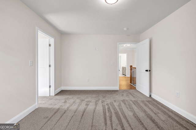 unfurnished room with light carpet