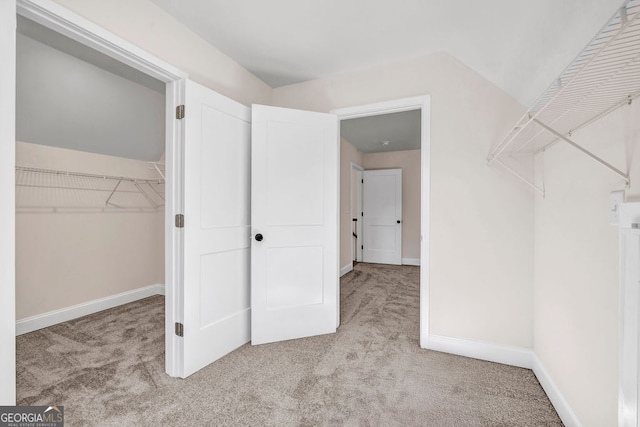 spacious closet with light colored carpet