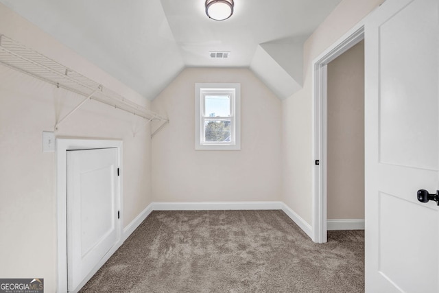 additional living space with lofted ceiling and light carpet