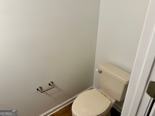 bathroom with toilet and wood-type flooring