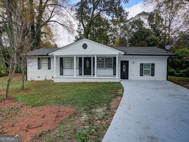 ranch-style home featuring covered porch and a front lawn