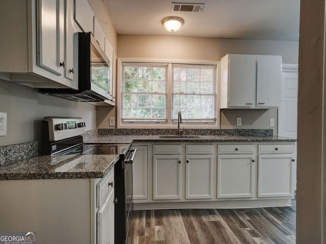 kitchen featuring white cabinets, appliances with stainless steel finishes, dark wood-type flooring, and sink