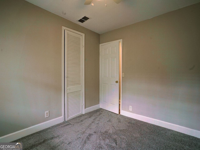 unfurnished bedroom featuring ceiling fan, a closet, and light colored carpet