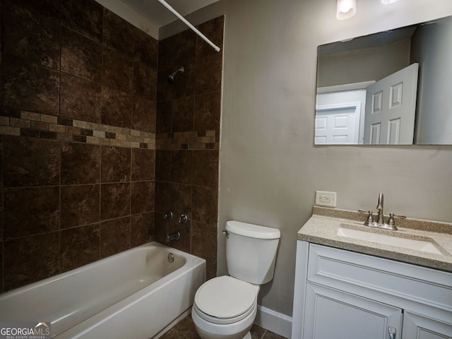 full bathroom featuring vanity, tiled shower / bath combo, and toilet