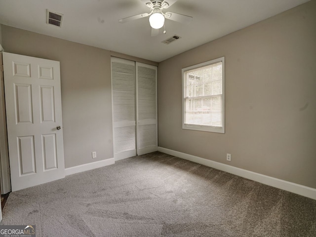 unfurnished bedroom featuring ceiling fan, a closet, and carpet floors