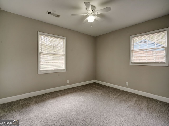 empty room featuring ceiling fan and carpet flooring