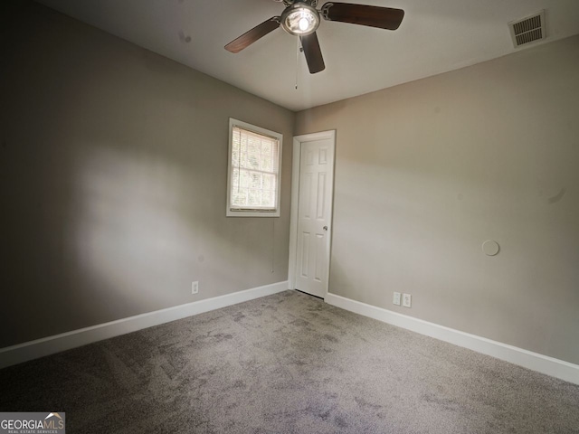 empty room featuring carpet and ceiling fan