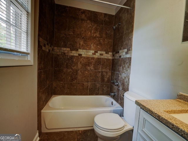 full bathroom with toilet, tiled shower / bath combo, vanity, and tile patterned flooring