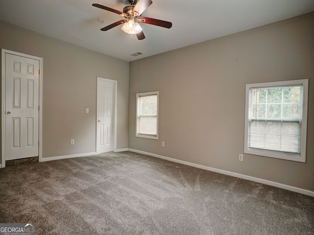 unfurnished room with carpet and ceiling fan