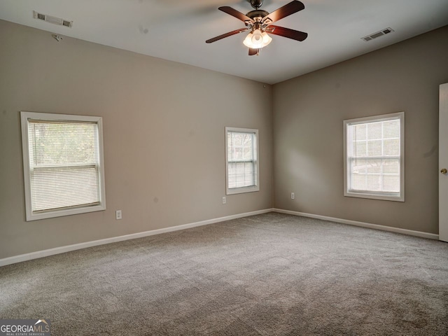 empty room with carpet, a healthy amount of sunlight, and ceiling fan