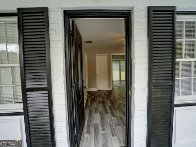 hallway with wood-type flooring