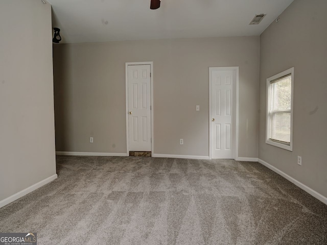 unfurnished room featuring ceiling fan and light carpet