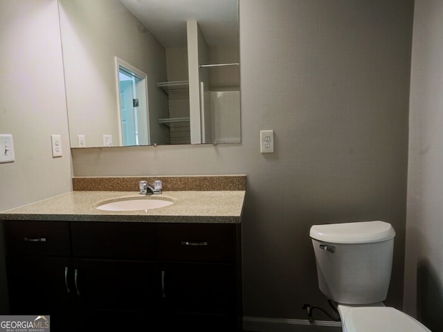 bathroom featuring toilet and vanity