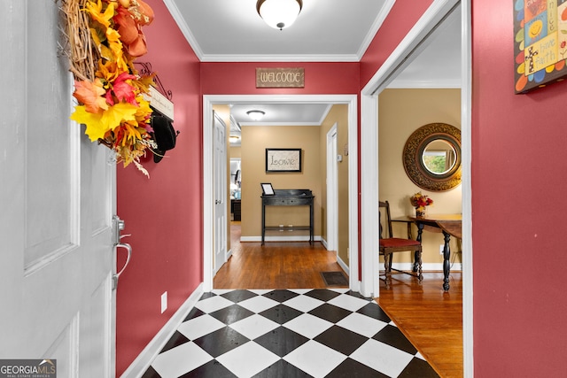 foyer entrance with dark hardwood / wood-style flooring and crown molding