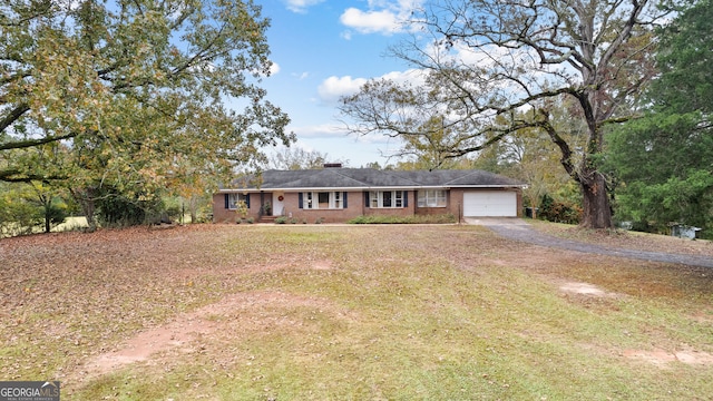 single story home featuring a garage and a front yard