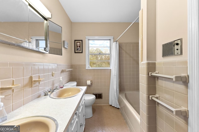 full bathroom featuring toilet, tile walls, tile patterned flooring, vanity, and shower / bath combination with curtain