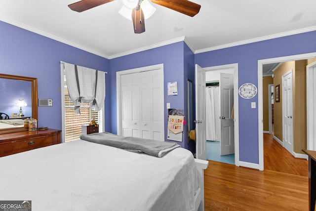 bedroom with hardwood / wood-style floors, ceiling fan, a closet, and crown molding