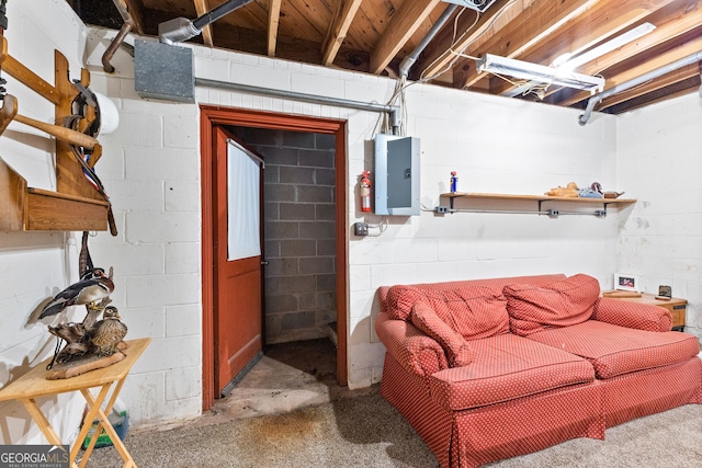 living room featuring electric panel and concrete floors