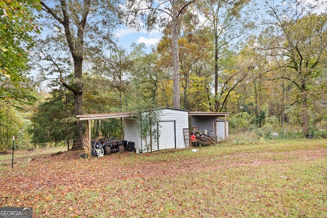 view of yard featuring an outbuilding and a carport