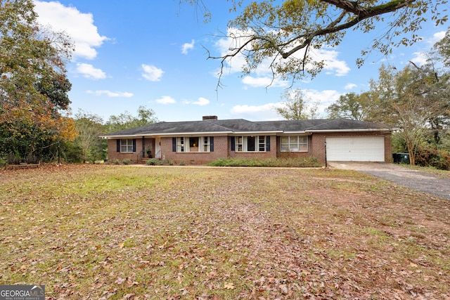 single story home featuring a garage and a front lawn